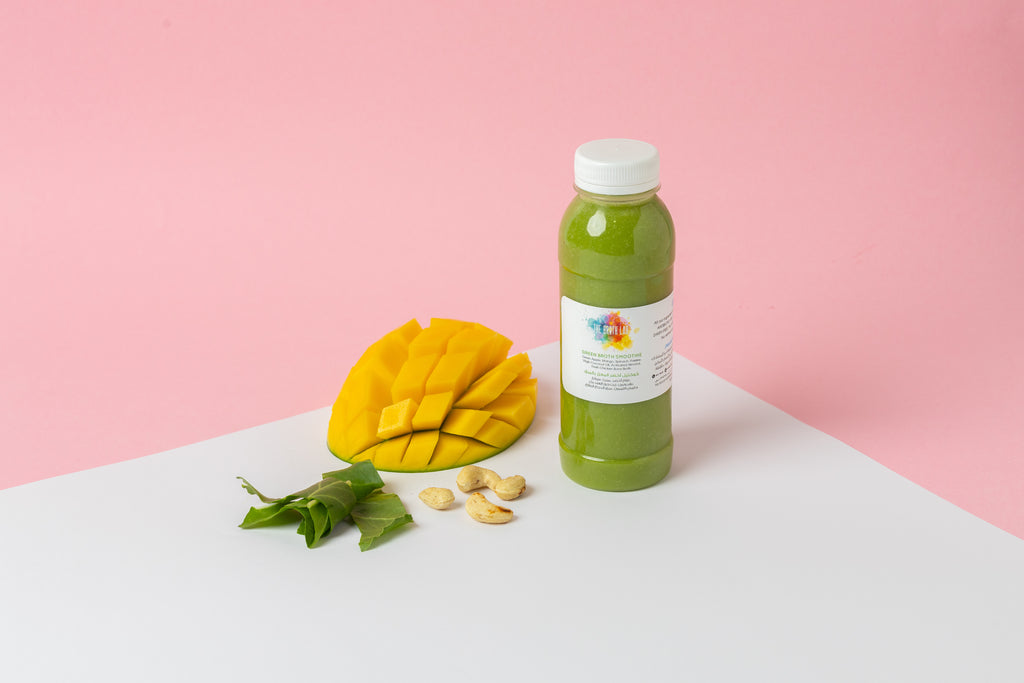 Green smoothie bottle with white cap and printed label