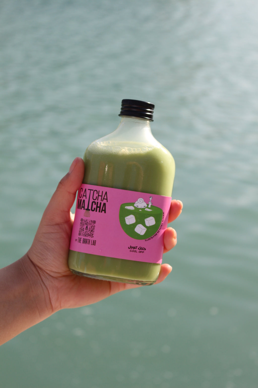 Matcha iced latte drink bottle with purple label and green beverage, capped bottle