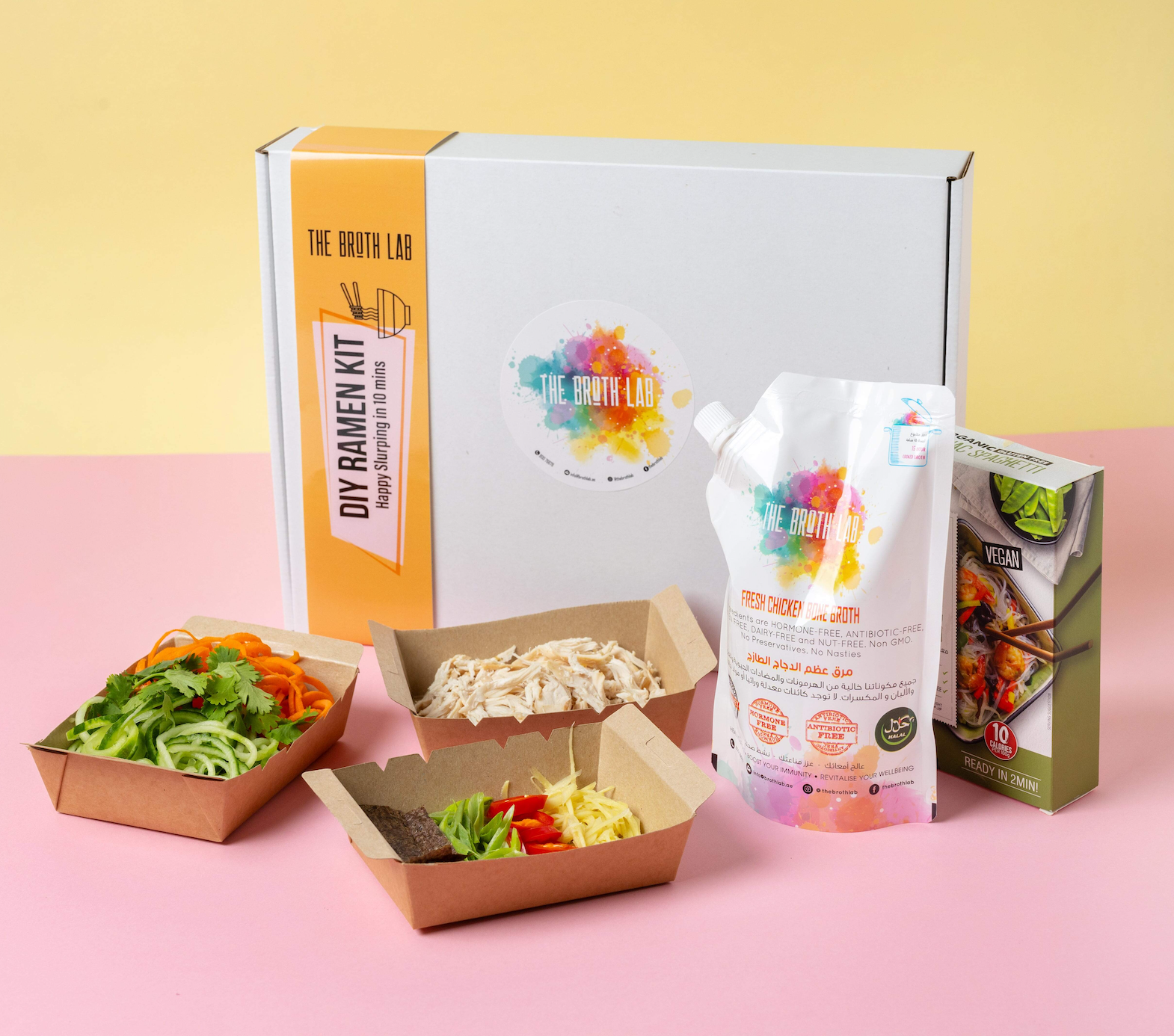 Ramen kit with open box, topping trays, and broth pouches